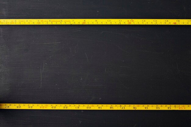 yellow measuring tape on black background