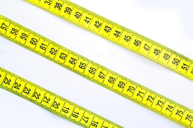 Yellow measuring tape or centimeter isolated on white background