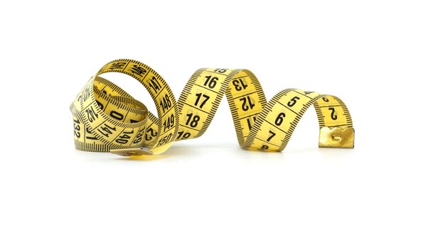 Yellow measuring tape spirals gracefully isolated on white