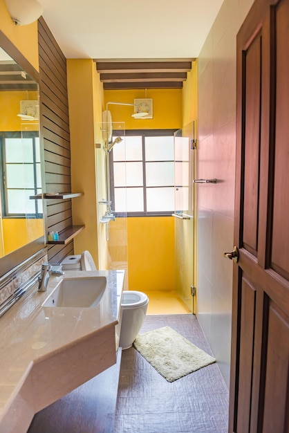 Yellow modern bathroom on a sunny day with bright sunlight