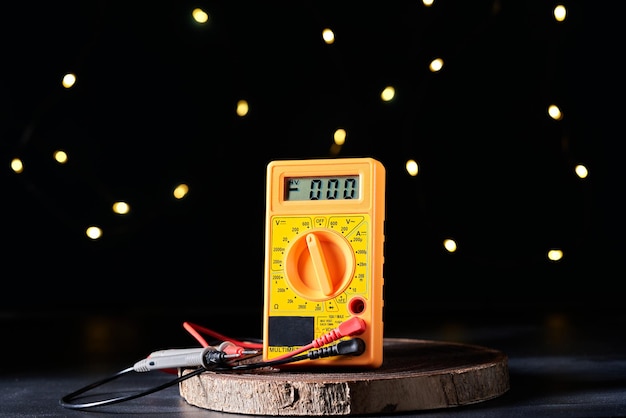 Yellow multimeter on a dark background