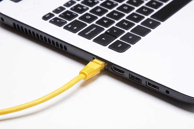 Yellow network cable connected to a laptop