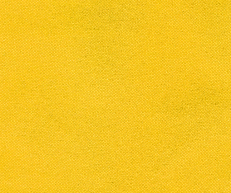 Photo yellow nonwoven polypropylene fabric texture background