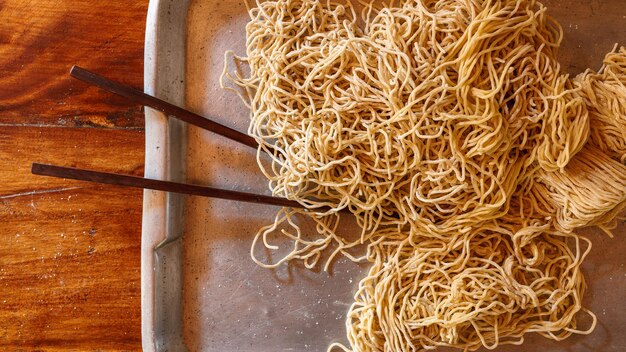 Yellow noodles in a tray on the kitchen table