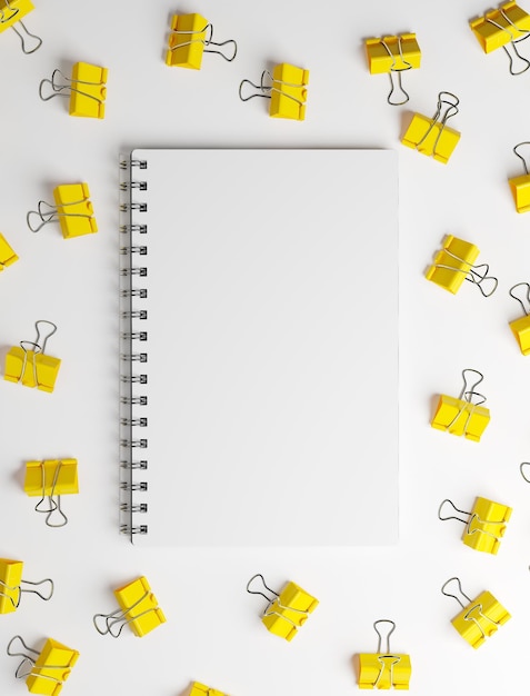 Yellow office clips on white table with white spiral notebook in the center Top view 3d rendering