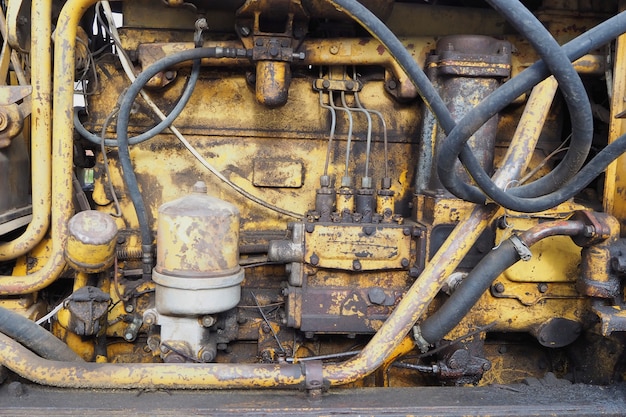 Yellow old tractor engine motor close up