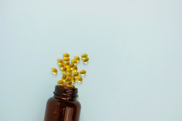 Yellow omega 3 capsule pattern. Different gold pills. Medical horizontal banner. Cosmetology wallpaper. Medicine vitamin.
