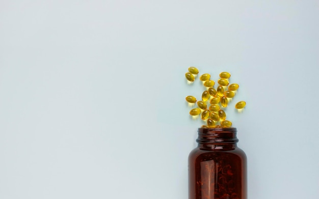 Yellow omega 3 capsule pattern. Different gold pills. Medical horizontal banner. Cosmetology wallpaper. Medicine vitamin.