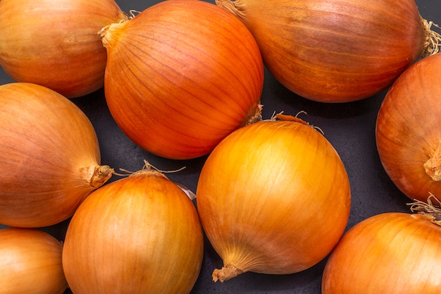 Yellow onion on black surface