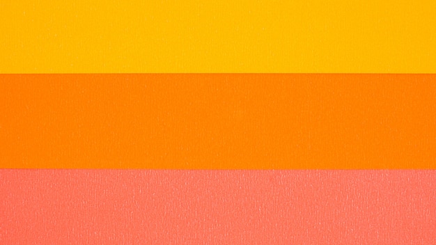 背景の黄色、オレンジ、ピンクの紙の質感