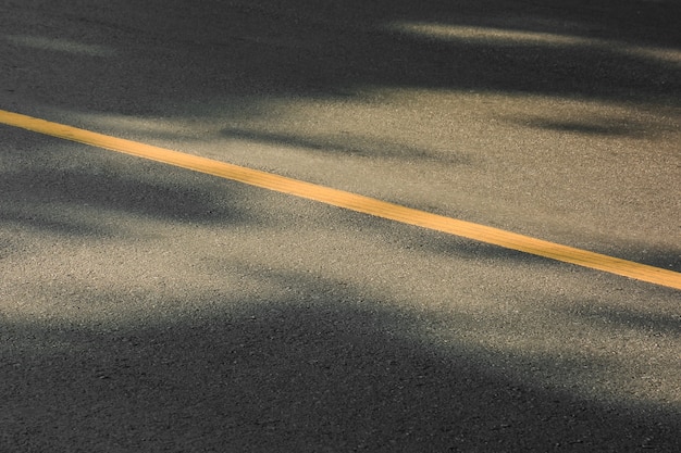 Yellow paint line on black asphalt. space transportation background