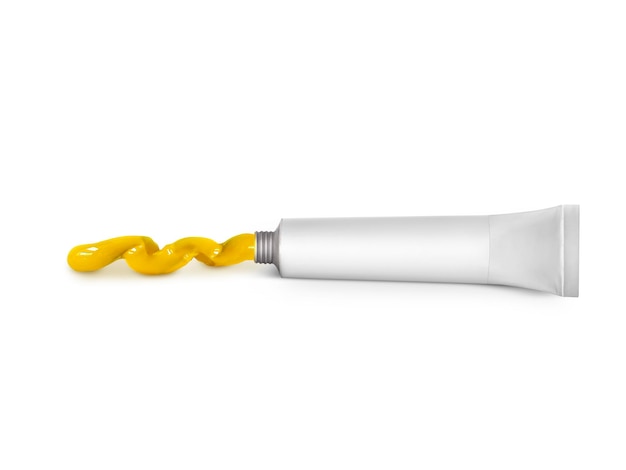 Yellow paint tin tube squeezed on white background isolated