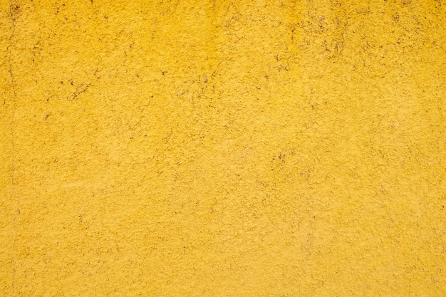 노란색 페인트 시멘트 벽 추상적 인 배경