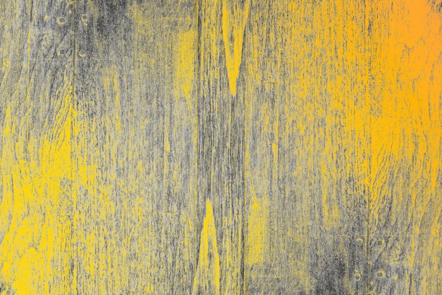 Yellow painted damaged old wooden surface