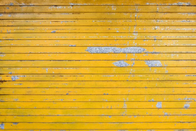 Yellow painted weathered garage door