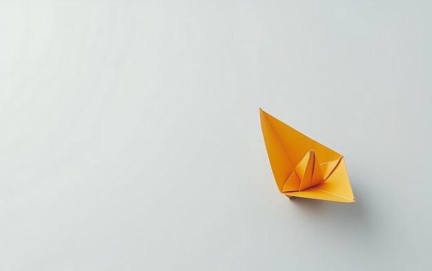 Photo a yellow paper boat with a yellow sail on it