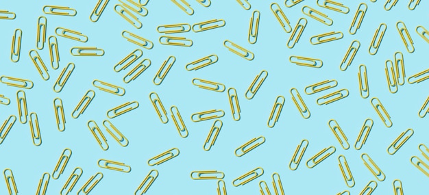 Yellow paper clip on blue background