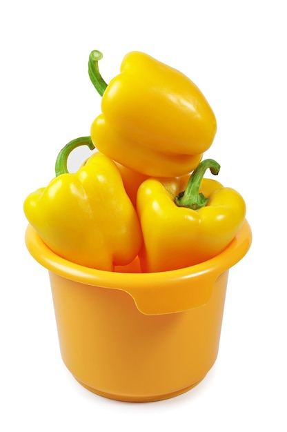 Yellow paprika in bowl on white background