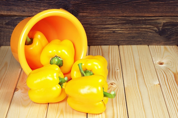 Yellow paprika in bowl on wooden table