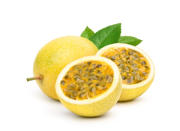 Yellow passion fruit with cut in half and green leaf isolated on white surface