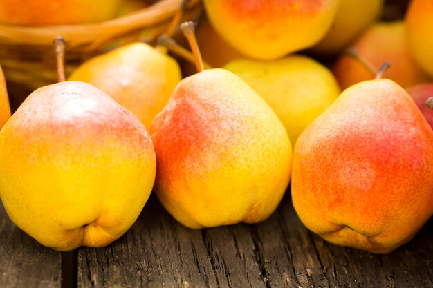 Yellow pears on wooden table in autumn