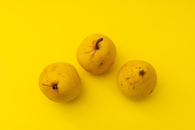 Yellow pears on a yellow background