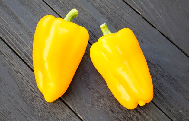 Yellow pepper on a black wooden background