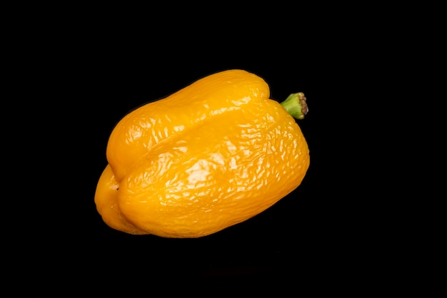 Yellow peppers on a black background