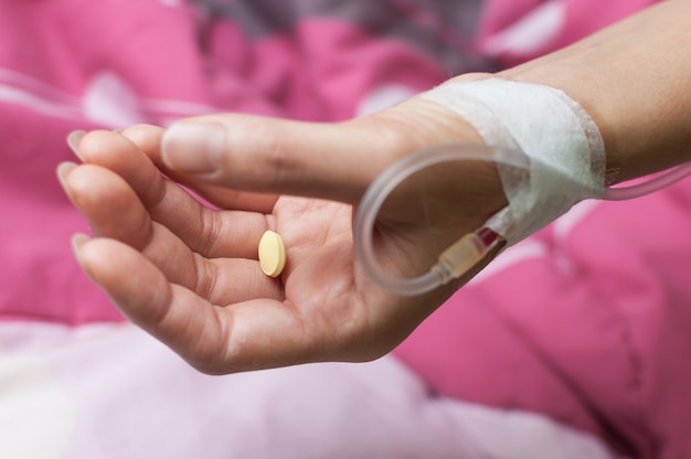 Yellow pill on patient's hand