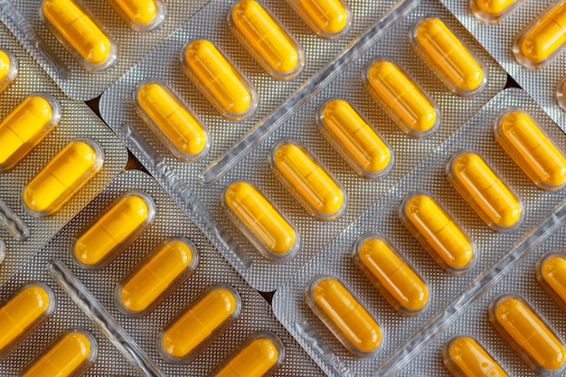 Yellow pills in a blister pack closeup