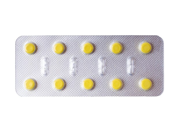 Yellow pills in a grey blister pack Closeup