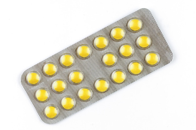 Yellow pills in a transparent blister