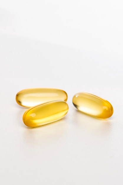 yellow pills on white background