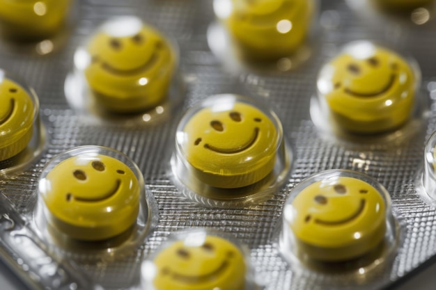 a yellow pills with smiley face circle