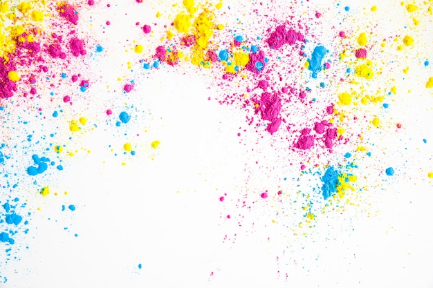 Yellow; pink and blue color powder on white background