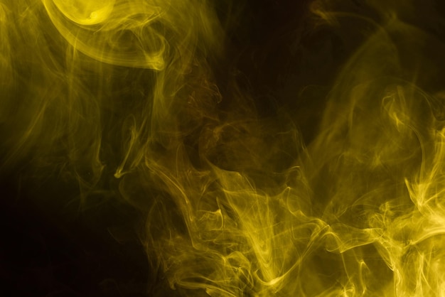 Yellow and pink steam on a black background. Copy space.