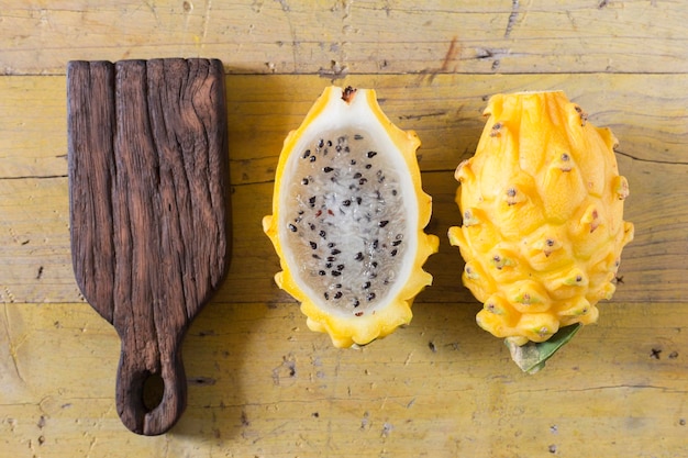 Yellow pitahaya dragon fruit on wooden background