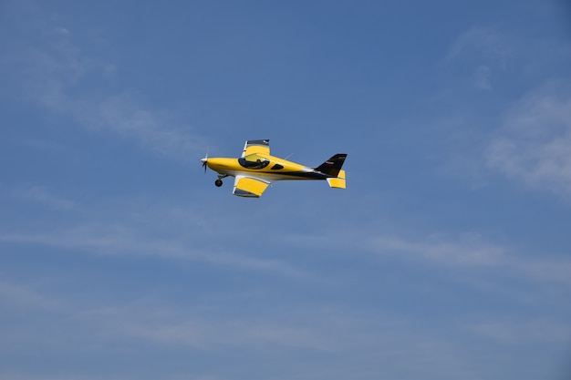 Yellow plane soars in the sky