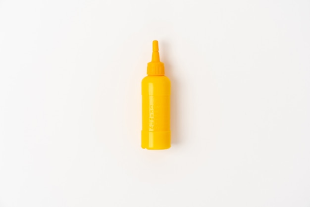 Yellow plastic bottle on white background