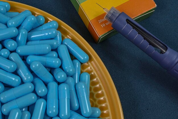 Yellow plate full of blue medicine capsules representing drug overdose