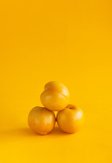 Yellow plum on a yellow background