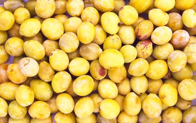 Yellow plums close up. Sweet ripe and overripe fruits