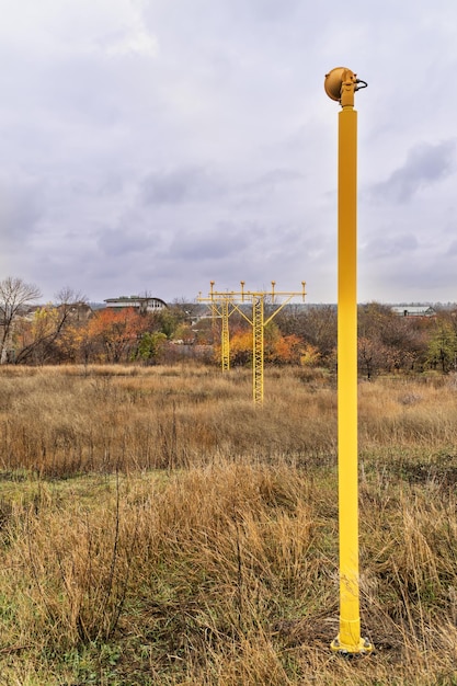 Yellow poles with landing lights for landing aircraft over houses