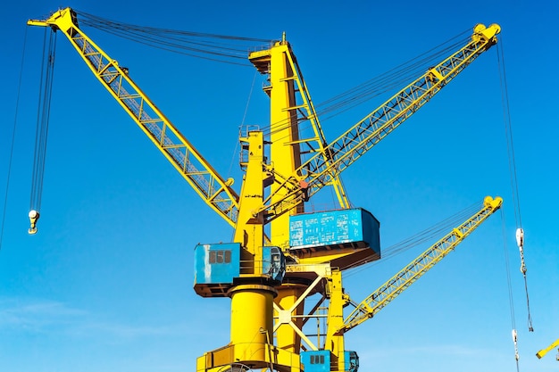 Yellow port cranes against the blue sky