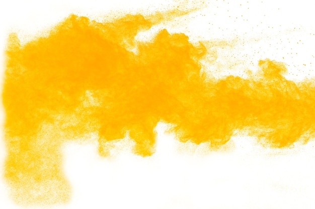 Yellow powder explosion on white background.