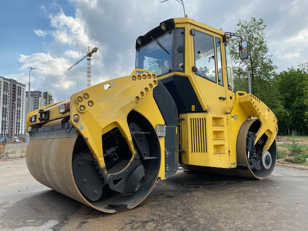 Yellow powerful large new modern road roller for asphalt paving and road repair at construction