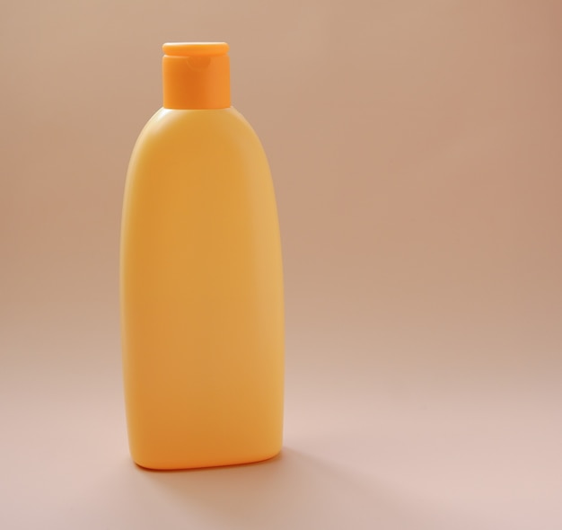 Yellow pure tanning lotion, baby shampoo or sunscreen bottle