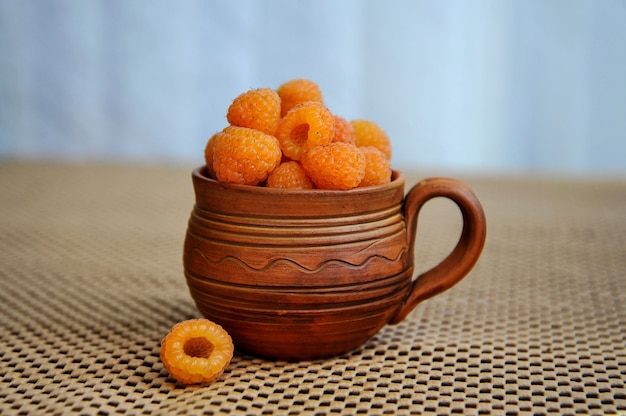 Yellow raspberry in a wooden bowl