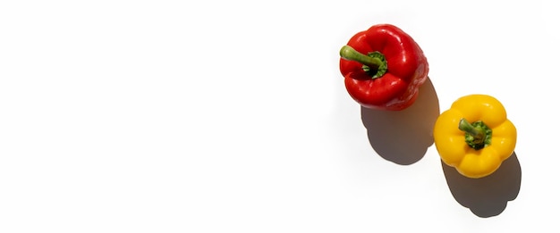 Yellow and red fresh peppers on a white background Top view flat lay Banner