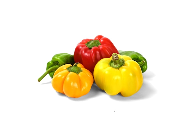 yellow and red and orange and green peppers white background